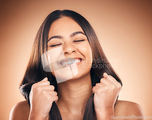 Image of Hair care, smile and woman with strong texture, eyes closed and isolated in studio on a brown background. Hairstyle, natural cosmetic and model with salon treatment for beauty, health or aesthetic