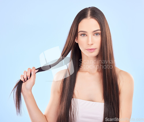 Image of Portrait, texture and woman with hair care, growth and cosmetics against a blue studio background. Female person, aesthetic or model with beauty, length and scalp treatment with luxury and shampoo