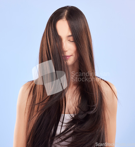 Image of Beauty, texture and woman with hair care, growth and wellness against a blue studio background. Female person, aesthetic and model with volume, scalp treatment and luxury with shampoo and cosmetics