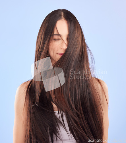 Image of Luxury, texture and woman with hair care, cosmetics and wellness against a blue studio background. Female person, aesthetic and model with volume, wavy and scalp treatment with self care and beauty