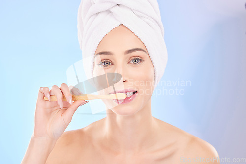 Image of Beauty, dental and brushing teeth with portrait of woman in studio for wellness, self care and skincare. Product, shower and cleaning with person on blue background for cosmetics and oral hygiene