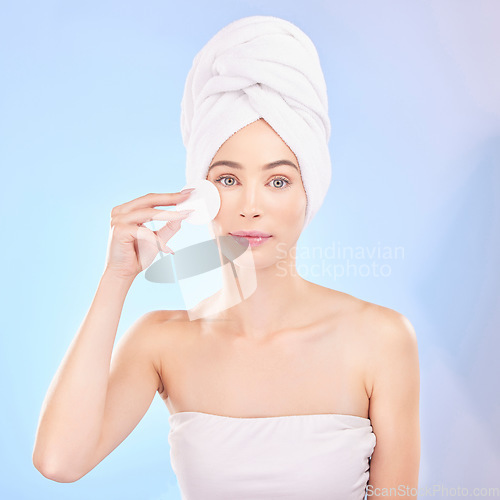 Image of Skincare, face pad and portrait of woman in studio for a natural, self care and spa routine. Beauty, health and young female model from Australia with clean skin treatment isolated by blue background