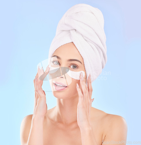 Image of Beauty, eye pads and portrait of woman in studio for natural, health and wellness routine. Skincare, cosmetic and young female model from Australia with a clean skin treatment by a blue background.