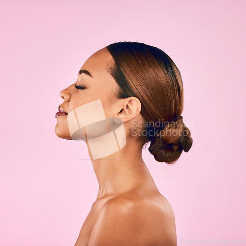 Image of Woman, skin and profile, natural beauty and skincare with cosmetic shine isolated on pink background. Female model, calm with makeup and dermatology, facial glow and wellness with self love in studio