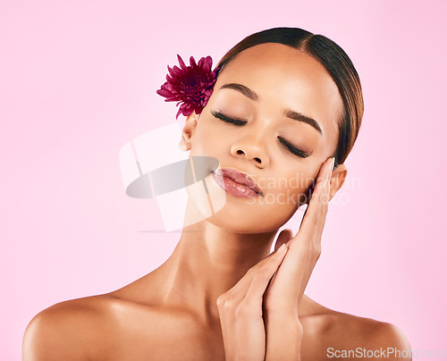 Image of Woman, face and flower, natural beauty and eco friendly skincare with nature aesthetic on pink background. Female model, cosmetic and sustainable dermatology, makeup and organic facial in studio