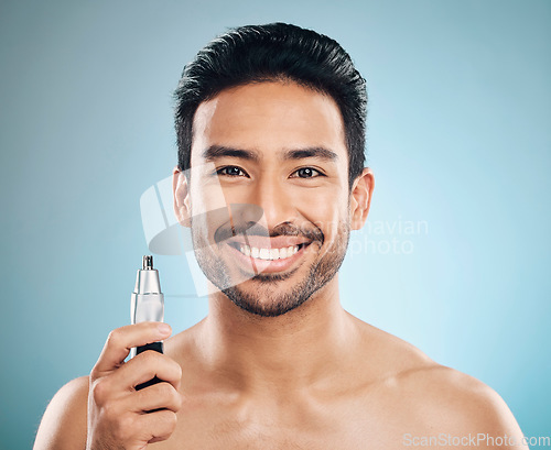 Image of Hair removal, face and man with beauty and trimmer, smile and cosmetic care isolated on blue background. Happy male model, tools and shaving, grooming and hygiene with body maintenance in studio
