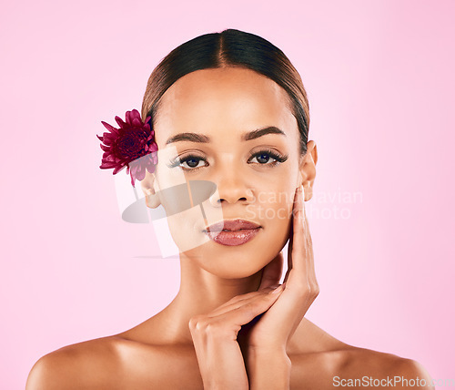 Image of Skincare, cosmetics and portrait of woman with flower, makeup and wellness glow on pink background. Natural beauty, dermatology and model with luxury facial care and healthy spa aesthetic in studio.