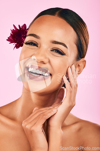 Image of Natural beauty, flower and portrait of woman with cosmetics, wellness and skin care glow on pink background. Makeup, organic dermatology and model with luxury facial care and healthy spa in studio.