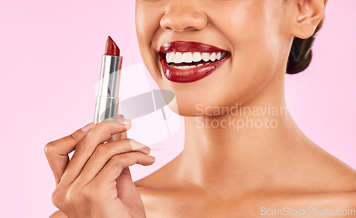 Image of Lipstick, red lips and woman with smile, beauty and skin with makeup closeup isolated on pink background. Female model, cosmetic product and shine, happiness and cosmetology with glow in studio
