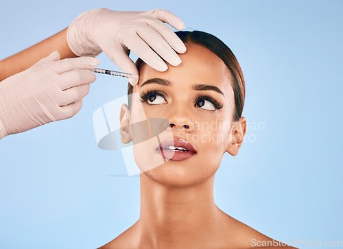 Image of Eyebrow, injection and beauty, woman and cosmetic surgery and dermatology isolated on blue background. Face, skincare and syringe, female model and doctor hands with liquid collagen in studio