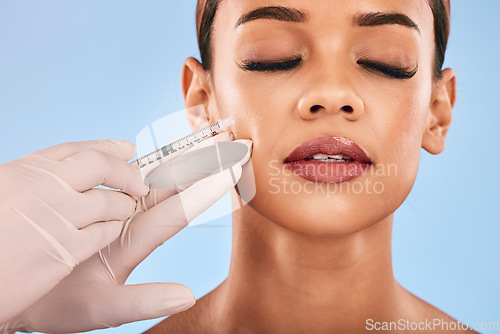 Image of Face, injection and beauty, woman and cosmetic surgery and dermatology isolated on blue background. Antiaging, skincare and syringe, female model and doctor hands with liquid collagen in studio