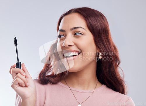 Image of Smile, beauty or happy girl with mascara makeup, cosmetics or product brush laughing in studio. Woman, face or female model with eyelashes tool for grooming, glamour or self care on white background