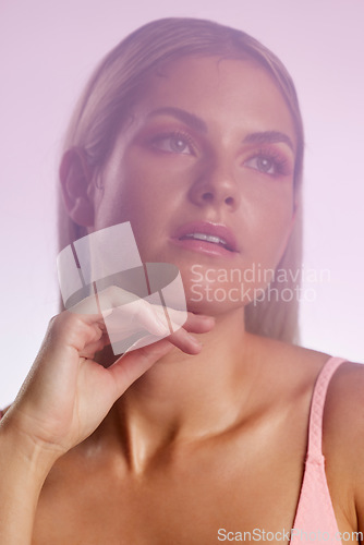 Image of Beauty, makeup and young woman in a studio with a natural, glamour and luxury face routine. Cosmetic, attractive and female model from Australia with facial cosmetology isolated by a pink background.