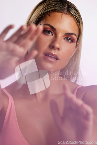 Image of Portrait, beauty and skincare with a model woman in studio on a gray background in red lighting for desire. Face, makeup or cosmetics with a young female person posing for natural feminine confidence