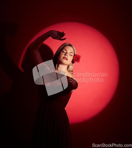 Image of Vintage, creative and a woman in a spotlight on a studio background for an art aesthetic. Fashion, retro and a young girl or rich model in a stylish dress or clothes isolated on a red backdrop