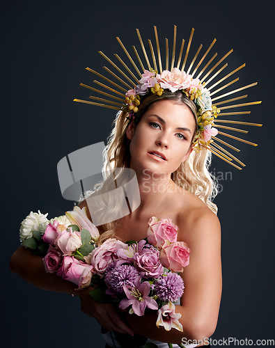 Image of Woman, flowers and crown in studio portrait for goddess, beauty or wellness for new beginning by black background. Girl, model and bouquet with plants, makeup and aesthetic for growth with cosmetics