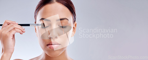 Image of Woman, eye makeup and brush, beauty banner and face with skincare isolated on white background. Mockup space, cosmetology and person apply foundation, cosmetics and tools with eyeshadow in studio