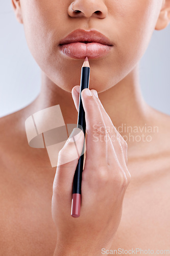Image of Hand, lips and pencil, woman and beauty with cosmetic product and makeup closeup isolated on white background. Female model, lipstick lipliner application and skin with cosmetology in a studio