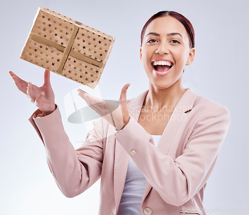 Image of Gift, happy and portrait of business woman in studio for shopping, surprise and birthday celebration. Wow, giveaway and prize with face of person and box on white background for package and present