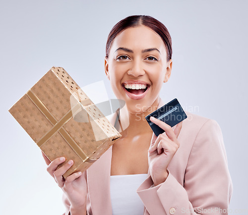 Image of Woman, credit card and gift box for prize, retail giveaway or payment success on studio white background. Happy person or winner portrait with present, finance bonus and shopping sale and e commerce