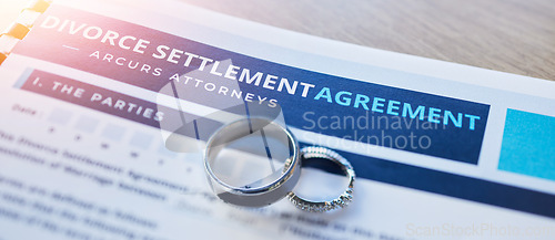 Image of Ring, lawyer and paperwork for a divorce agreement, legal certificate or document for marriage. Closeup of deal, court and attorney report on end of relationship or contract for family law on a desk