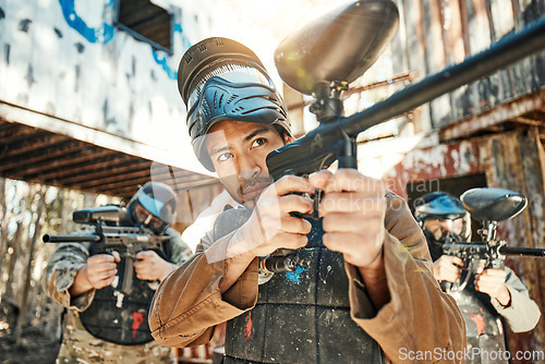 Image of Paintball game, gun or team focus on shooting competition, challenge or military mission, arena practice or conflict. Target aim, soldier teamwork or people in survival war, action or battle training