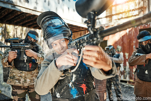 Image of Paintball team, gun and woman aim, focus and shooting at target practice, competition or military conflict, fight or mission. Group, soldier or people point weapon in survival war, training or battle