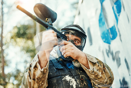 Image of Paintball gun, gear and man aim, shooting and target soldier, warrior or training competition for battlefield fight, conflict or challenge. Army mission, male shooter and military focus on war battle