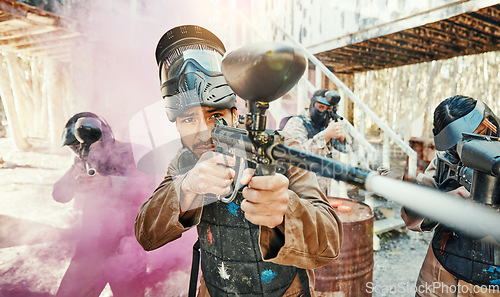 Image of Teamwork, smoke and paintball with man in game for playground, war and sports gaming. Challenge, mission and soldier with people shooting in battlefield arena for target, gun and warrior training