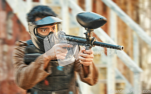 Image of Paintball, sports and man in action with blur for tournament, competition and battle in nature. Target, military and male person shooting in outdoor arena for training, adventure games and challenge