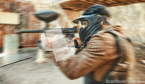 Image of Paintball, sports and man in action blur with gun for tournament, competition and battle. Target, soldier and person shooting in outdoor battlefield arena for training, adventure game or challenge