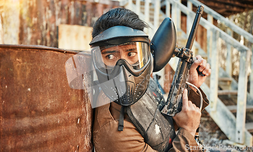 Image of Paintball, adventure and man in action with gun for tournament, competition and battle in nature. Extreme sports, military and male person shooting in outdoor arena for training, games and challenge