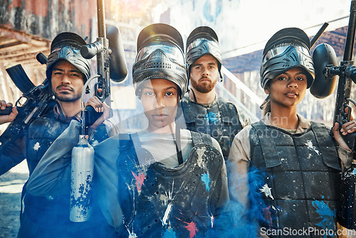 Image of Paintball, focus and portrait of team or people ready for a battle and teamwork or collaboration together. Serious, sports and army on a mission on the battlefield with guns for outdoor competition