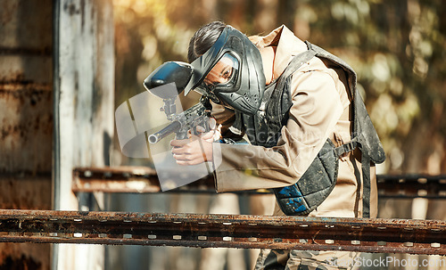 Image of Paintball game, gun shooting and woman focus on player challenge, target aim or military conflict fight. Mission, soldier and female sniper pointing weapon in survival war, action or battle training