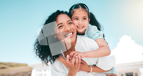 Image of Hug, piggyback and mom with her girl child playing outdoor in the garden at their family home. Happy, smile and young mother carrying her kid on her back bonding and playing together in the backyard.