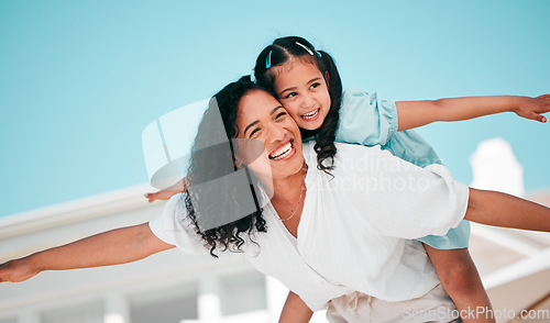 Image of Smile, airplane and mother with her child in the outdoor garden at their family home for adventure. Playful, happy and young mom carrying her girl kid on her back while bonding and playing together.