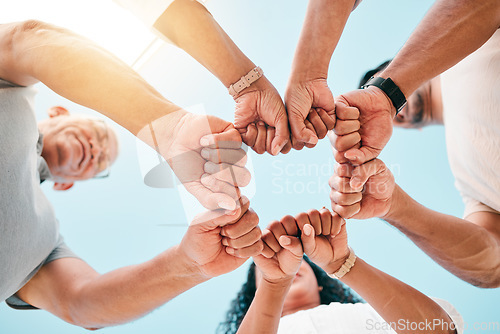 Image of Fist bump, hands and business people with support on sky background for teamwork, solidarity or low angle commitment. V, sign and team power sign in collaboration, partnership or goal motivation