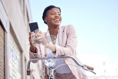 Image of Happy business woman in city with bike, phone and morning commute, checking location or social media. Eco friendly transport bicycle, cycling and African girl with mobile app, smile and work travel.