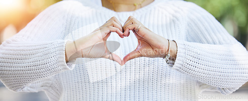 Image of Love, heart and peace with hands of woman in nature for support, motivation and kindness. Thank you, lens flare and hope with closeup of person and sign in outdoors for emoji, health and banner