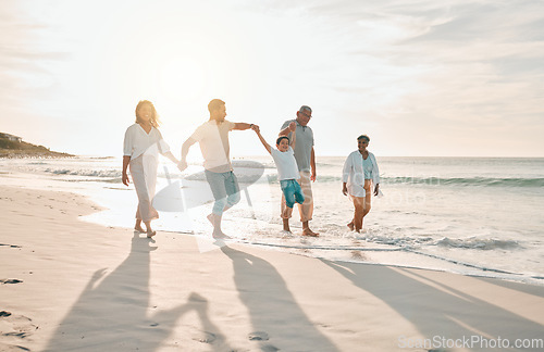 Image of Holding hands, swing and big family at the beach walking with freedom, travel and bonding at sunset. Love, lifting and and boy child with grandparents and parents at sea on walk for summer holiday