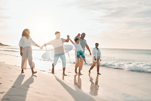 Image of Holding hands, big family and swing at the beach walking with freedom, travel and bonding at sunset. Love, lifting and and boy child with grandparents and parents at sea on walk for summer holiday