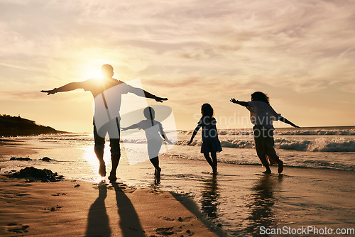 Image of Silhouette, family is running on beach and back view with ocean waves, sunset and bonding in nature. Energy, action people outdoor on tropical holiday and freedom, travel with trust and love