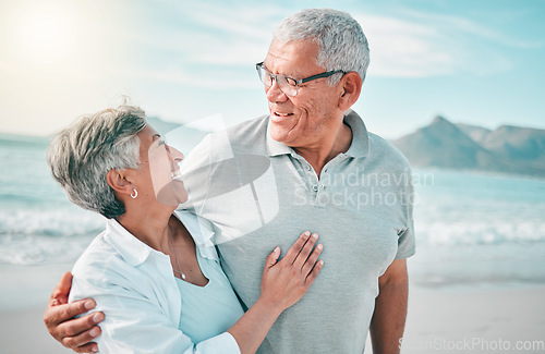 Image of Happy, hug or old couple laughing on beach with love, care or support on summer vacation in nature. Retirement, mature man talking or funny senior woman at sea or ocean to travel on holiday together