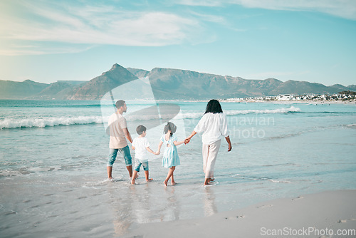 Image of Family walk on a beach, holding hands and bonding in nature, back view with ocean waves and summer in Mexico. Parents, kids and people outdoor on holiday, freedom and travel with trust and love