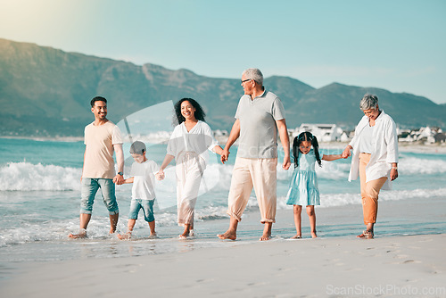 Image of Generations, holding hands and walking family on beach and ocean waves, freedom and bonding in nature. Grandparents, parents and kids, people outdoor and travel with trust and love on Mexican holiday