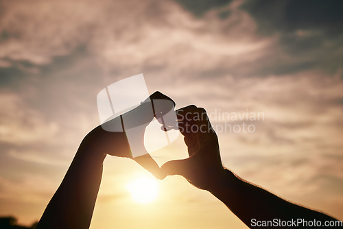 Image of Heart hands, sunset on beach and silhouette with love and romance sign, people travel and outdoor. Adventure, emoji and care with health in nature, support and commitment, couple with trust and sea