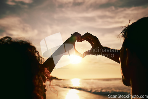 Image of People with heart hands, sunset on beach, silhouette with love and romance sign, travel and outdoor. Adventure, emoji and care with health in nature, support and commitment, couple with trust and sea