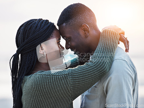 Image of Couple, beach and touch forehead outdoor for love, care and commitment. Profile of a young black man and a happy woman together on a romantic vacation, holiday or sunset travel adventure in Jamaica