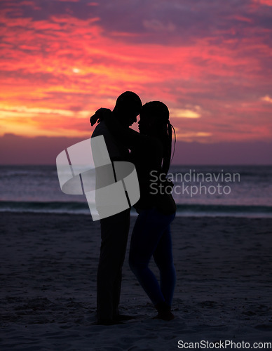 Image of Couple, sunset and silhouette outdoor at the beach with love, care and commitment. Romantic man and woman hug or affectionate on vacation, holiday or nature travel adventure with sunrise sky on date