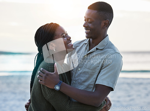 Image of Black couple, hug and happy outdoor at the beach with love, care and commitment. Smile on face of young african man and woman together on vacation, holiday or sunset travel adventure in Jamaica